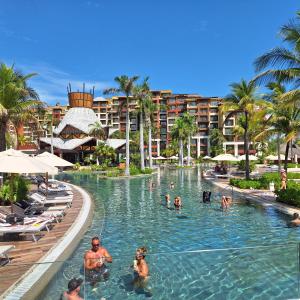 a group of people in the swimming pool at a resort at Villa del Palmar in Cancún