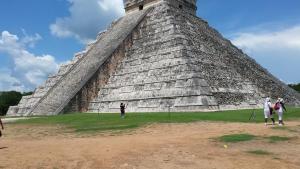 a group of people standing in front of a pyramid at Villa del Palmar in Cancún
