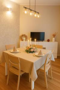 a dining room with a table with candles on it at Apt Matteucci 18 centro storico con parcheggio privato in Ravenna