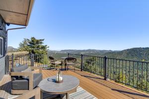 a balcony with a table and chairs on a deck at The View at Mountain Retreat By Red Rocks and Golden in Evergreen
