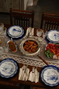 a table with blue and white plates of food at Historical Villa Santa Croce in Pirgos +48 photos