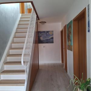 a staircase in a house with white rails at Pension mit Meer in Cuxhaven