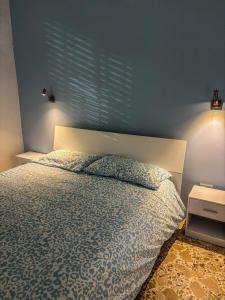 a bedroom with a bed with a blue wall at Il fico d'india in Marsala +18 photos