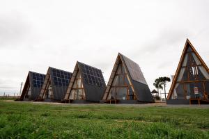 a group of triangular buildings with solar panels at Mont Hermon Hotel Castro in Castro