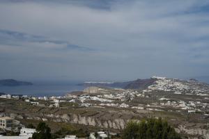 a view of a town on a mountain with the ocean at Historical Villa Santa Croce in Pirgos