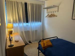 a bedroom with a bed and a table with a lamp at Contractor friendly-2 bd-Private Parking-Sleeps 3 in Llandeilo +5 photos