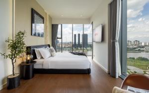 a hotel room with a bed and a large window at Lè Métropole Saigon in Ho Chi Minh City
