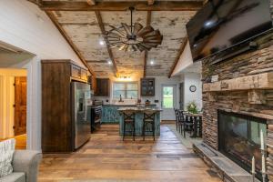 an open kitchen and living room with a stone fireplace at Up the Creek in Linville