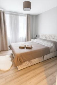a bedroom with a large bed with two towels on it at 2 bedroom apartment limerick in Limerick +1 photo