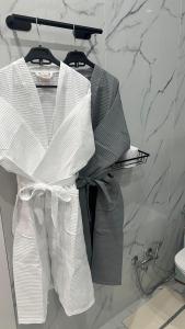 a group of white towels on a rack in a bathroom at Евро двушка in Astana
