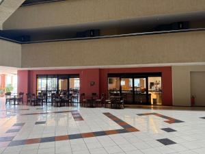 un ristorante con tavoli e sedie in un edificio di Flat - Iate Plaza Hotel a Fortaleza