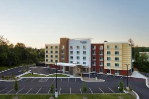 an aerial view of a hotel with a parking lot at Fairfield by Marriott Inn & Suites Beckley in Beckley
