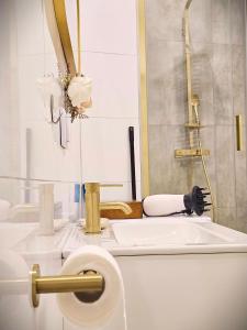 a bathroom with a toilet and a sink at Apartamenty Paryskie Old Town View in Toruń +64 photos