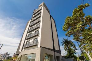 a tall white building with balconies on it at Studio Completo para 5 Pessoas Com Garagem-EIX0505 in Curitiba