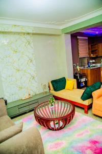 a living room with a couch and a coffee table at Blaize Affaire Apartments in Kampala