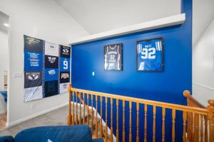 a blue wall in a baby room with jerseys on it at The BYU Fan Club - Close to BYU - Family Retreat in Lindon
