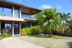 a palm tree in front of a house at Sol Sanctum - Boutique Wellness Hotel in Gros Islet +16 photos