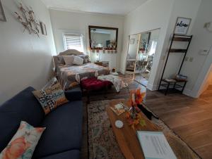 a living room with a couch and a bed at Cozy, Cute, Private Ozark Suite 5 Mins to Hospital in Ozark