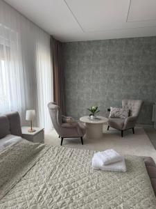 a bedroom with a bed and a table and chairs at Raj in Subotica +21 photos