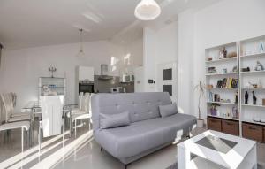 a white living room with a couch and a table at House Dragica in Imotski