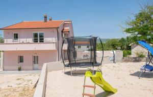 a playground with two swings and a slide at House Dragica in Nenadići
