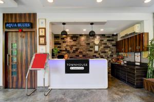 a restaurant with a counter with avertisement for at Super Townhouse New Digha Formerly Hotel Coral in New Digha