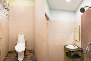 a bathroom with a toilet and a sink at Super Townhouse New Digha Formerly Hotel Coral in New Digha