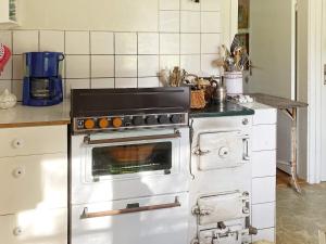 a kitchen with an oven in a kitchen at 6 person holiday home in Ingatorp in Ingatorp