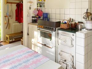 a kitchen with a stove and an oven at 6 person holiday home in Ingatorp in Ingatorp +18 photos