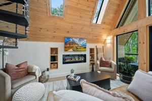 sala de estar con techo de madera y ventanas en Ascent A-Frame at Calm Ridge Treehouses, en Boone
