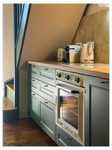 a kitchen with a counter with a stove top oven at Maisons Mage Sauge in La Celle-sous-Gouzon