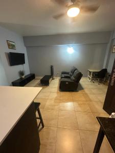 a living room with a couch and a table at Central 1 bedroom New Kingston in Kingston