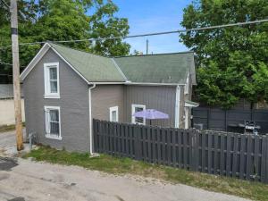 a house with a fence in front of it at CGV - Unique and Memorable 3BDR Stay in Columbus