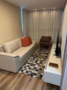 a living room with a couch and a table at Apartamento Premium Lazer Completo, Rooftop e Academia in Belém