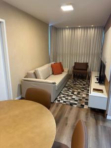 a living room with a couch and a table at Apartamento Premium Lazer Completo, Rooftop e Academia in Belém