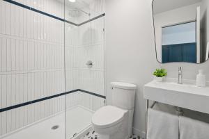 a bathroom with a shower and a toilet and a sink at Lakelyn Lodge in Lakeville