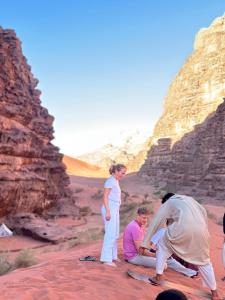 a group of people standing in the desert at The Legacy of Wadi Rum in Wadi Rum +31 photos