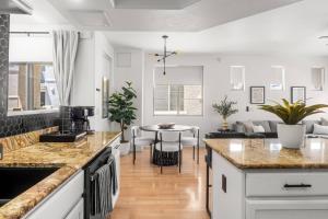 a kitchen and living room with a table and chairs at Freestanding Cubs Retreat near ASU off L-101 & 202 in Tempe
