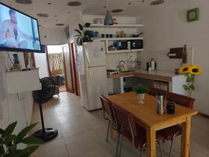 a kitchen with a table and a television in a room at Espacio R&P in Santa Clara del Mar