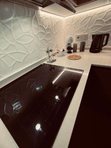 a kitchen with a counter with a sink in it at La casa di Nonna Afra in Agerola
