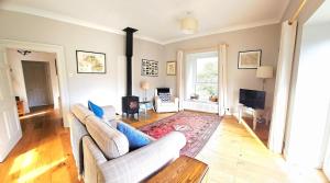 a living room with two couches and a television at Folly View - Private, peaceful apartment with stunning views. in Pateley Bridge