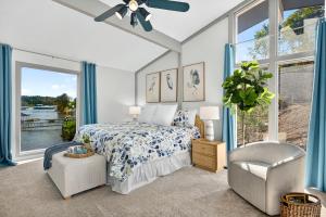 a bedroom with a bed and a chair and a window at Lake Home Oasis - Sleeps 18 in Lake Ozark