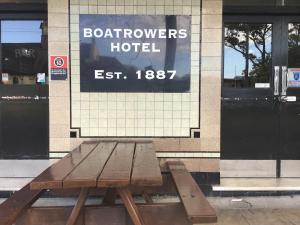 a wooden bench sitting in front of a hotel at The Boatrowers Hotel in Stockton