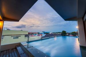 a swimming pool on the roof of a building at Seng Hout Hotel in Battambang
