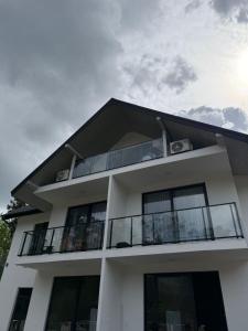 a white building with a balcony and the sky at WHITE HORTENZIA Guesthouse in Batumi