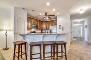 a kitchen with wooden cabinets and bar stools at Sunset Island - 35 Fountain 3E in Ocean City +30 photos