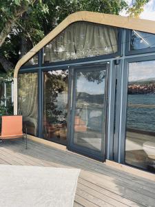 a house with large glass windows on a deck at ISH Danube Village in Orşova