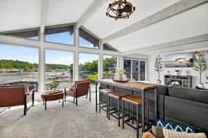 a large living room with a table and chairs at Lake Home Oasis - Sleeps 18 in Lake Ozark
