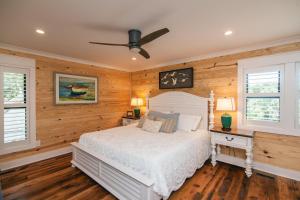 a bedroom with a white bed and wooden walls at T-Time in Edisto Island +50 photos
