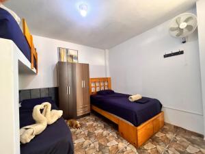 a bedroom with two beds and a dog laying on the floor at Casa Rosé Vacacional in Santa Rosa +26 photos